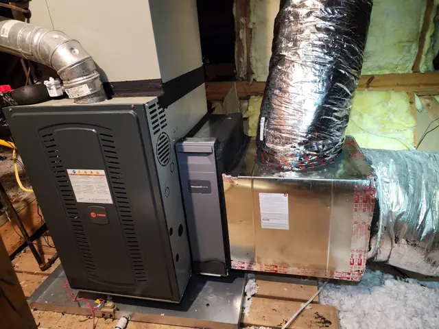 Trane furnace beside a Honeywell Home media air cleaner and a new sealed supply plenum