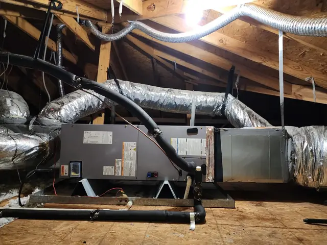 Attic air handler mounted on a new galvanised stand with mastic sealed flex trunk lines running to it