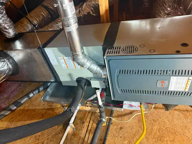 Furnace in a Spring attic with a new B-vent flue elbow, condensate line and yellow gas flex connector